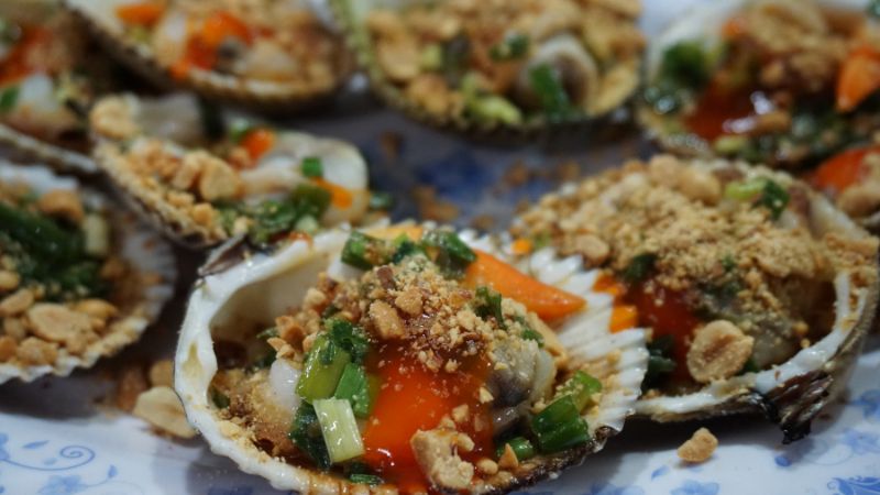 Fresh seafood platter by the beach in Danang Vietnam with grilled prawns, crab, and clams