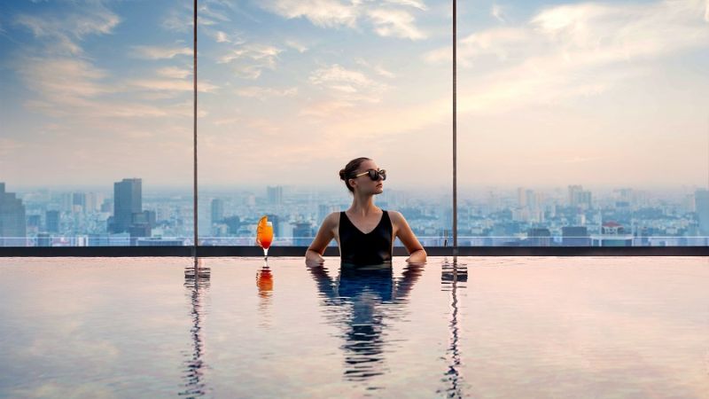 Hotels in Ho Chi Minh City: Your Complete Guide for the Perfect Stay 7 Travelers relaxing at rooftop pool in a five-star hotel in Ho Chi Minh City