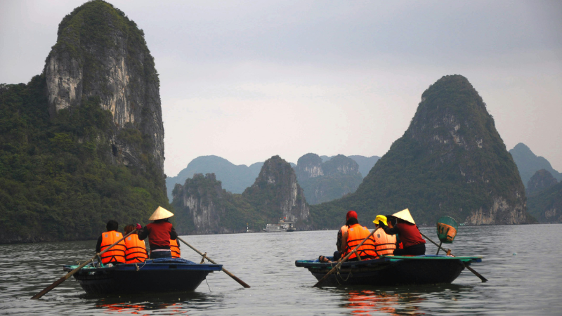 Ha Long Bay boat tours include kayaking and bamboo boat rides through hidden lagoons