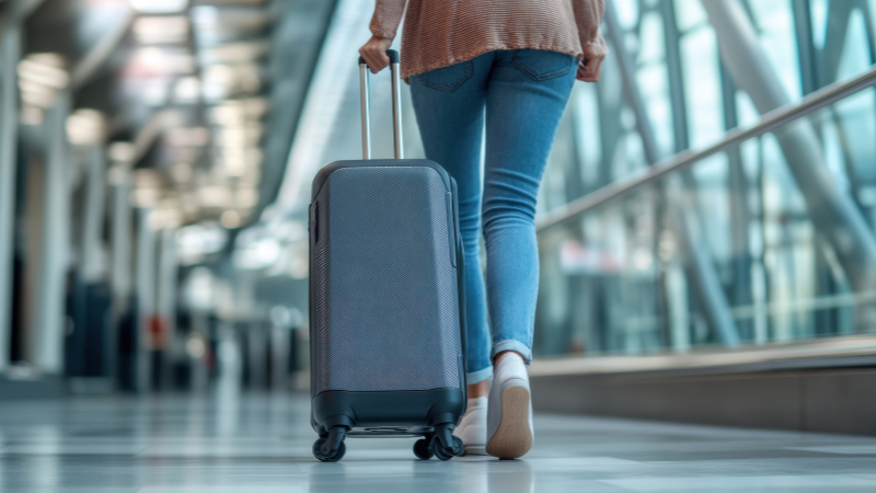 Traveler walking through airport with luggage after smooth entry using eVisa Vietnam agency services