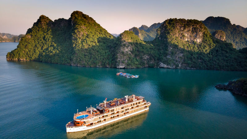 Luxury Halong Bay cruise overnight ship sailing among emerald waters