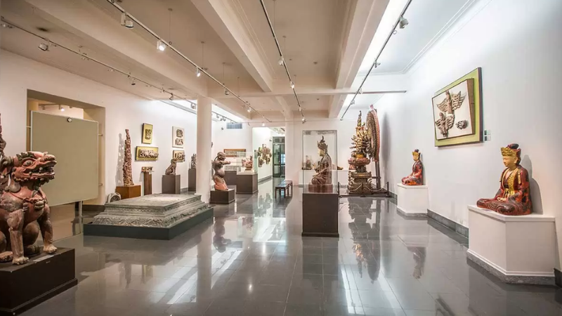 Wooden and stone Buddhist statues in the Fine Arts Museum Hanoi gallery