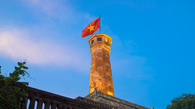Close-up shot showing the architectural details and octagonal top of the Hanoi Flag Tower