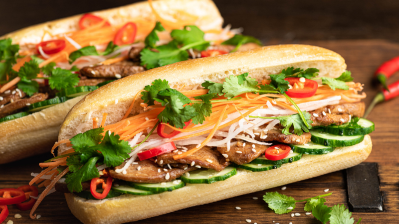 Hanoi Street Food Tour: A Flavorful Journey Through the Capital’s Best Local Eats 3 Hanoi Old Quarter street food stalls with tourists enjoying local dishes