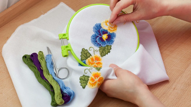 Embroidered tablecloths and artwork displayed in a Nha Trang embroidery shop